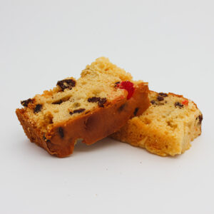 Kaye's Bakery fruit luncheon cake sliced and sitting on top of one another on a white background